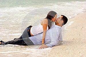 Two lovers kissing at waters edge photo