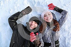 Two lovers people lie on snow photo