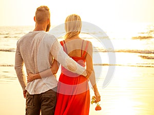 Two lovers people at sunset by the sea romance and tenderness feelings first love date.man and woman blonde in a dress