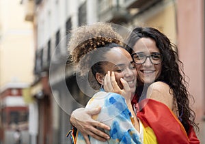 two loving lesbian women walking down the street in Madrid city with copy space