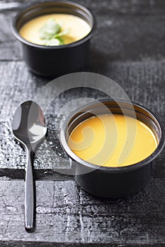 Pea and avacado soup in plastic food containers, spoon and copy space photo