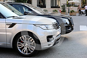 Two Luxurious SUVs Parked In Front Of Monte Carlo Casino In Mona