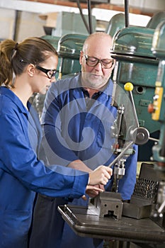 Two machinists working on machine