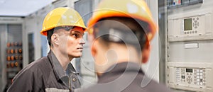 Two maintenance engineer work on relay protection system