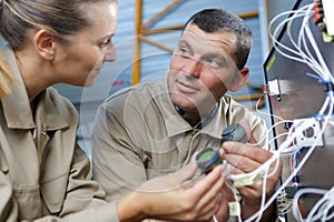 two maintenance engineers checking cables