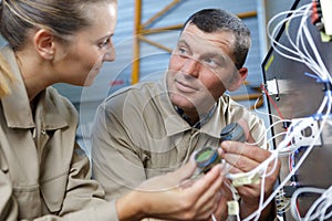 two maintenance engineers checking cables
