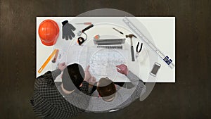 Two male architects discussing drawings and blueprints photo