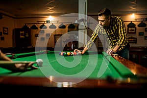 Two male billiard players leisures in poolroom