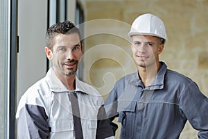two male builders looking at camera