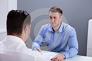 Two Male Business Partner Having Discussion At Workplace