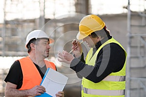 Two male civil engineers at work