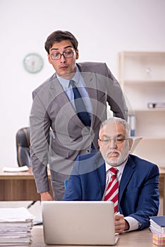 Two male colleagues sitting in the office