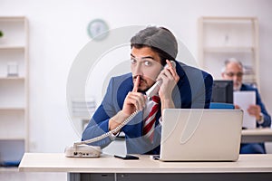 Two male colleagues working in the office