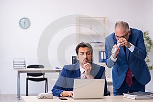 Two male colleagues working in the office