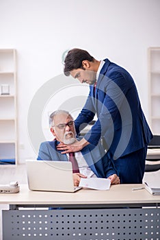 Two male colleagues working in the office