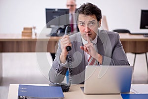 Two male colleagues working in the office