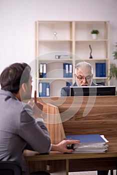 Two male colleagues working in the office