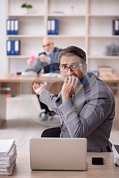 Two male colleagues working in the office