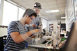 Two Male College Students Building Machine In Science Robotics Or Engineering Class photo
