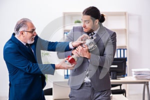 Two male employees working in the office