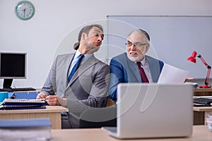 Two male employees working in the office