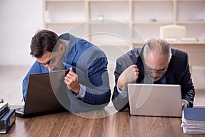 Two male employees working in the office