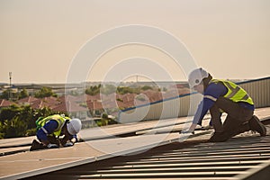 Two male engineer install solar panels