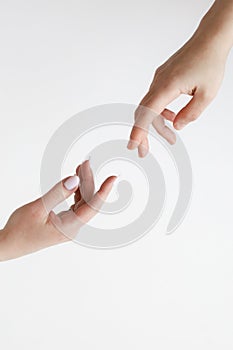 Two male hands reaching towards each other on isolated white background. Two male hands are trying to touch, like a