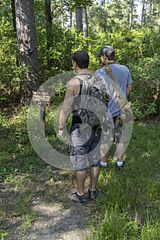 Two Male Hikers Going Into National Forest