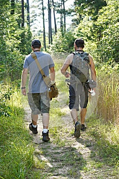 Two Male Hikers Going Into National Forest