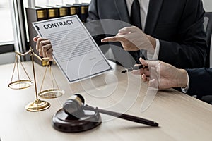 Two male lawyers are consulting together to draft a contract acknowledgment for their clients.