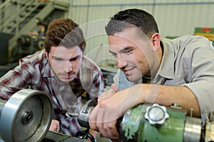 Two male mechanics working in garage