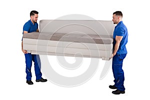 Two Male Movers Carrying Sofa