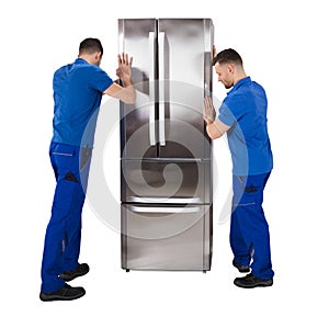 Two Male Movers Placing The Refrigerator