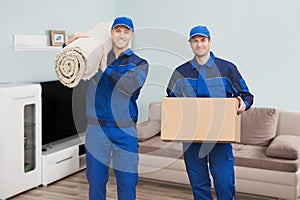 Two Male Movers Standing In House