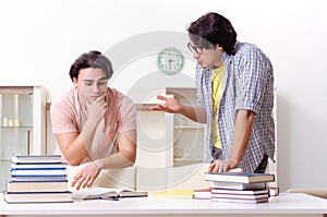 Two male students preparing for exams at home