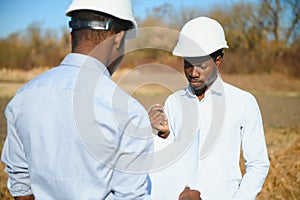 Two male surveyors working at mining site
