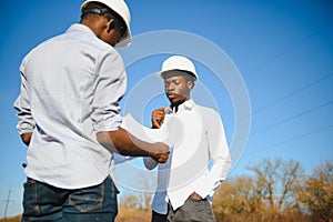 Two male surveyors working at mining site
