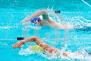 Male swimmers competing in freestyle stroke