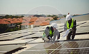 Two male technicians install solar panels