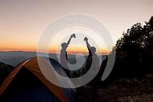 Two male tourists are happy at the top of the mountain.