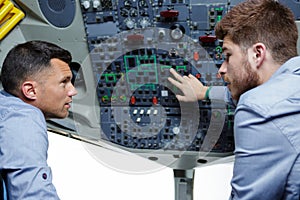 two males in cockpit discussing about commands