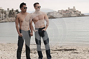Two males next to the sea
