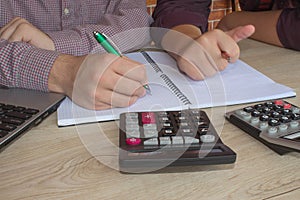 Two man accountants counting on calculator income for tax form completion hands closeup. Internal Revenue Service inspector checki