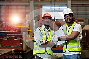 Two man African American engineer workers standing work success in manufacturing factory workplace. happy man engineering at