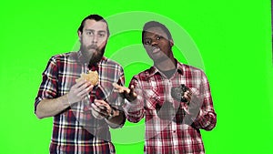 Two man eating burgers