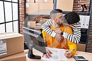 Two man ecommerce business workers kissing and working at office