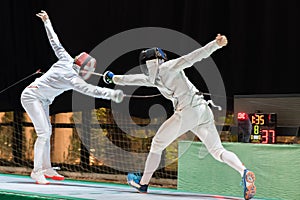 Two man fencing athletes fight