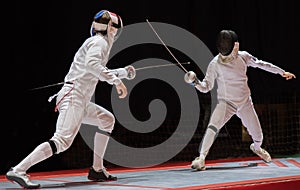 Two man fencing athletes fight