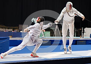 Two man fencing athletes fight